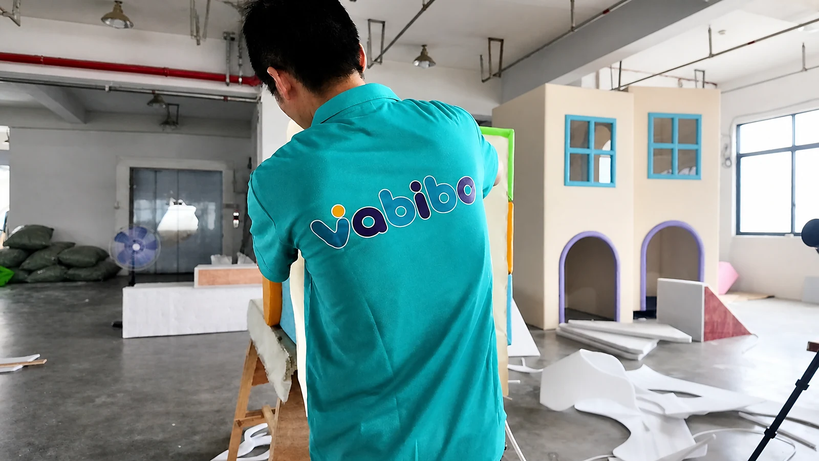 Vabibo team member working on a padded indoor playground module