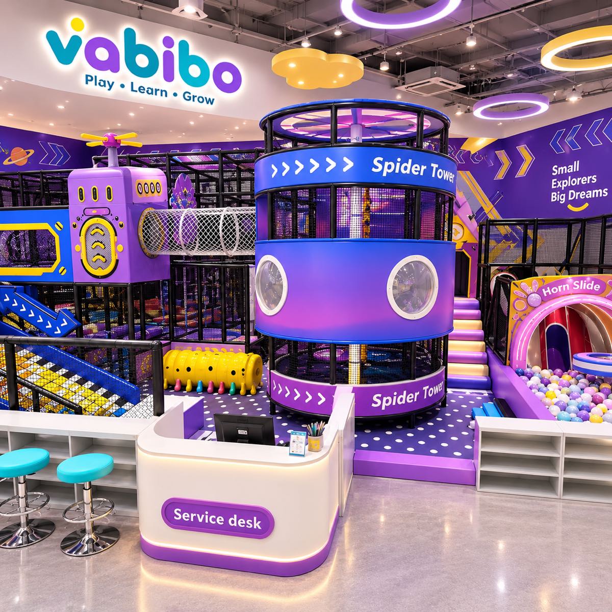 Purple space-themed indoor playground with a central play tower and reception